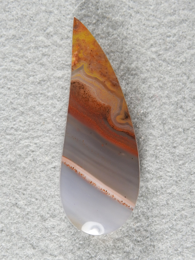 Apache Flame Agate 1927  :  A very tall curved teardrop of Apache Flame.  The White band is a nice contrast adding focus the the clear drop.