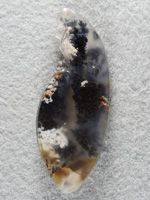 Singleton Plume Agate 1556 : Another cab where I incorporated the natural bubbly chalcedony in the cut with a nice long black plume.