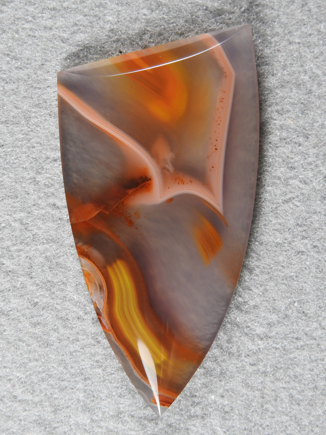 Apache flame agate 312  :  Lots of action in this cab with Apache colors and the very pretty White floating section in the with Yellow center and Red dendrites floating on it.