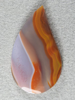 Apache Flame Agate 1725 : A very big collectors cab of Apache Flame. This cab has a white area filled with fine red dots. Proportions in this pattern are perfect.