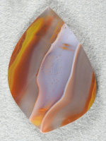 Apache Flame Agate 1896  :  A very big collectors cab with the classic Apache ribbons and a beautiful White ribbon with Orange dots floating in it.  Very Showy!