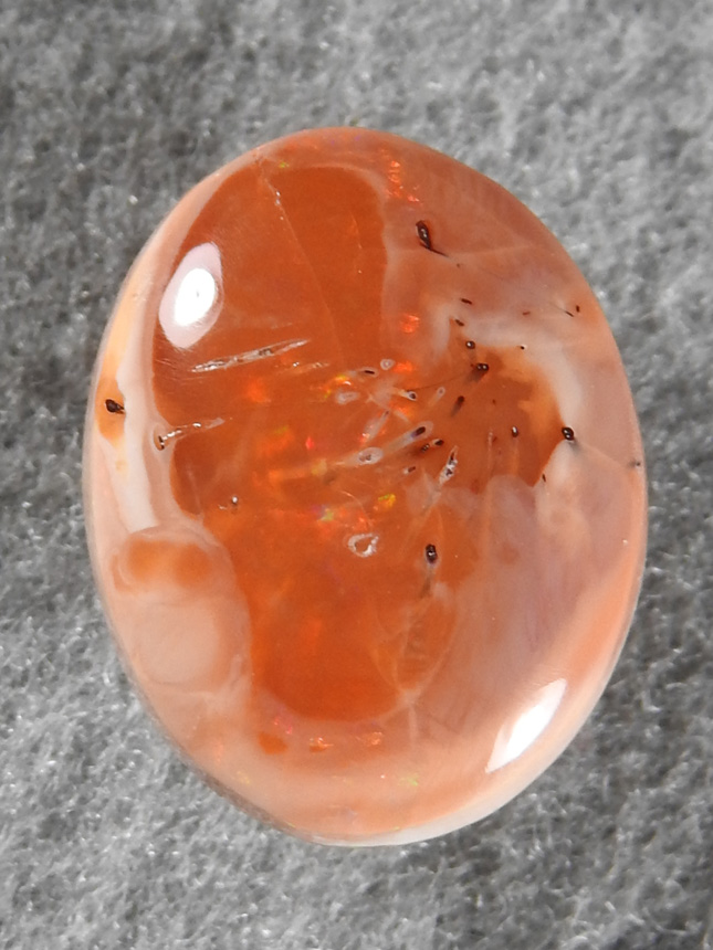 Fire Opal 1737 : Small Mexican Honey Opal with needles and a nice Red flash.