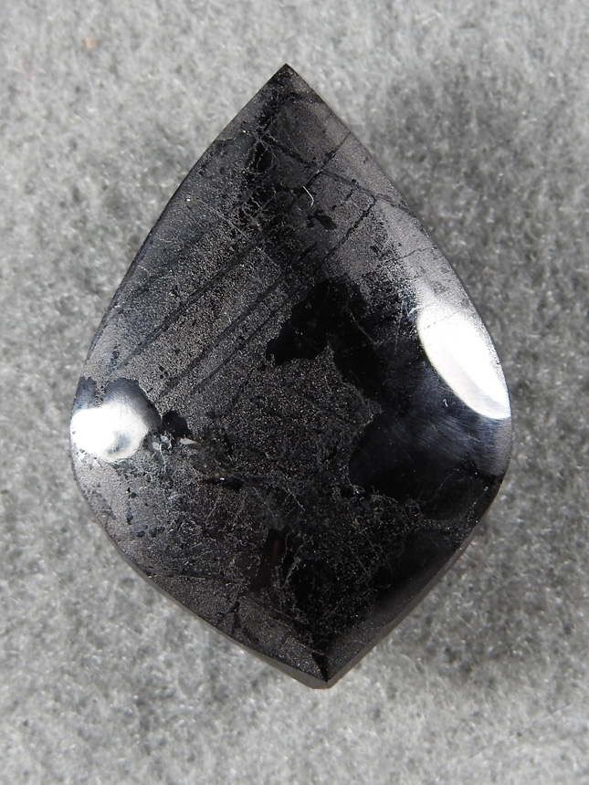 Ilmenite 2077 : Unusal to see a cab of this material.  I discovered large masses of this Titanium/Iron in the San Gabriel Mountains. Looks like meteorite when cut.