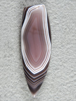 Botswana Agate 1282  :  A lushious cab with as perfectly captured pattern. This stone is a sure fire winner. Line bot/left is light reflection.
