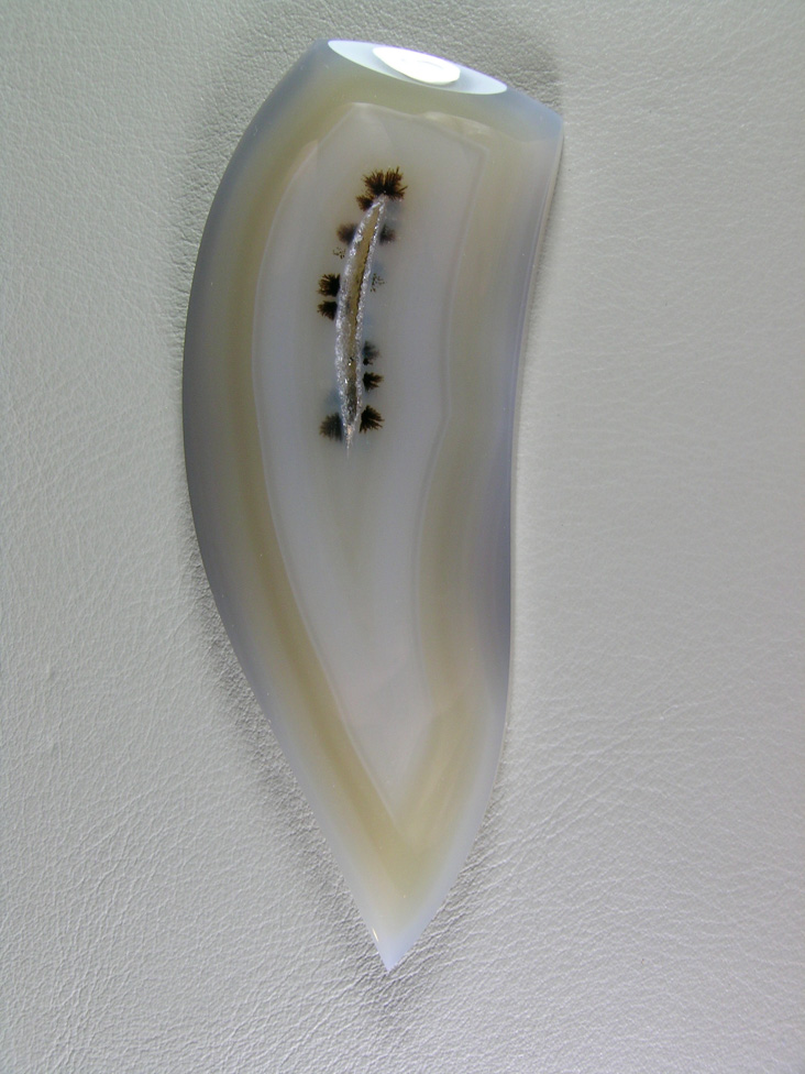 traded D Brazilian Agate 574:  A very large cab of just the best Brazilian.  This milky cab gives an almost ghostly appearance around these Black Dendrites surrounding a Druzy center.  Truly an amazing and elegant cab.
