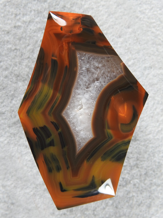 Condor Agate 635  :  A very dramatic cab.  I used the negaive shapes of the fortification to decide the shape of the cab cutting several negatives.  Condor is very hard and takes a perfect polish.