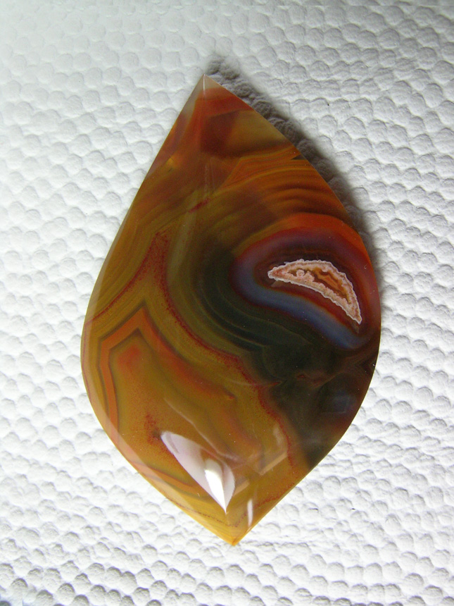 Traded Condor Agate 638:  I loved this stone but he picked it on his share.  A very pretty stone with that light pattern in the middle of the Red and Black.