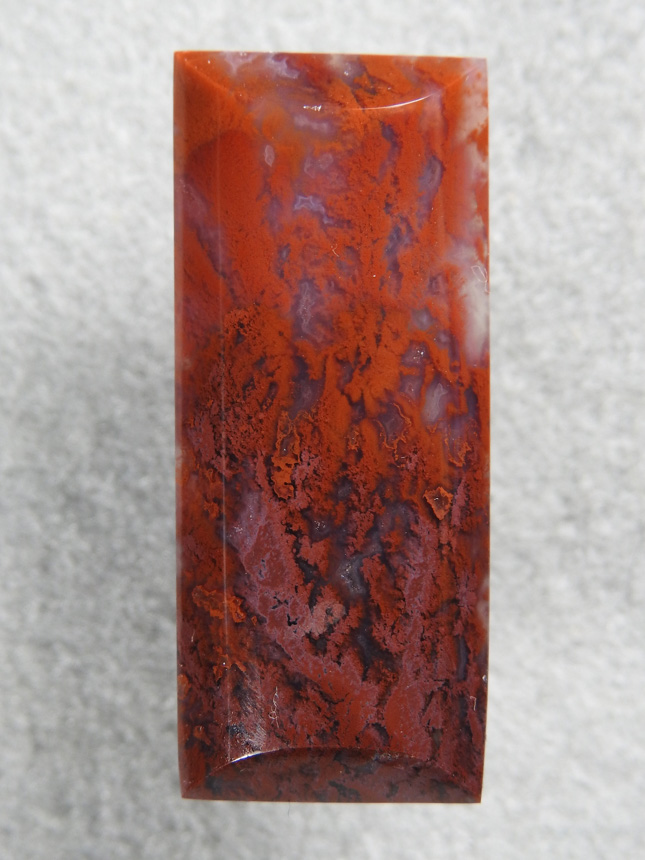 Coronary Plume Agate 642  :  An elongated half barrel this cab would make an excellent necklace.  It has well defined plumes from Red to Plum.