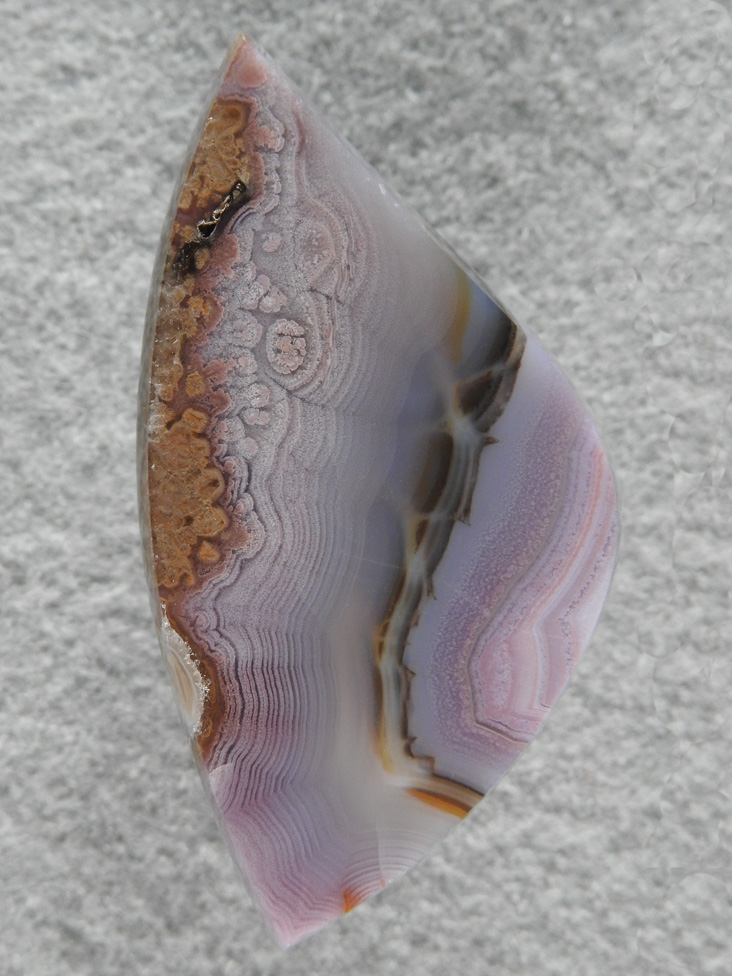 Coyamito Agate 215  :  I cut many cabs of this beautiful Purple Agate.  The Black band and almost poppy texture towards the outter bands really makes very nice cabs.