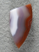 Coyamito Agate 1463 : Gemmy Red White and a Blueish Lavendar center band.  Small badge shape to follow Red bands. Nice material.