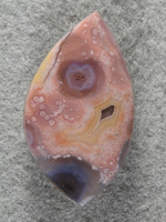 Coyamito Agate 1464 : Uncommon Pinks and with Yellow and clears, a very nice cab.  Small dots in the agate also make this a keeper.