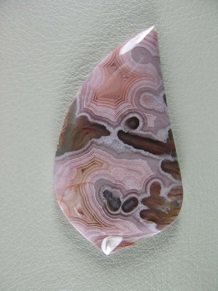 traded Coyamito Agate 242T  :  I was given 4 slabs of this exotic color Coyamito to cut and the patterns and tubes combined with the Pink and Brown colors to make some striking cabs.