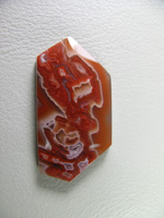 traded Coyamito Agate 241T  :  A cab of exceptional Psuedomorph Agate from Coyamito in Cherry Reds. The cab follows the Crystal forms nicely, perfect for a pendant