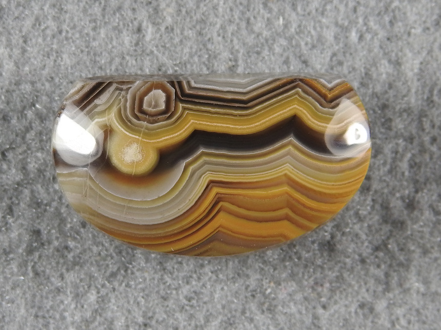 Crazy Lace Agate 1965 :  This was a 30mm oval that had a vug when cutting.  A redesign brought this to life awaiting a pendant setting.