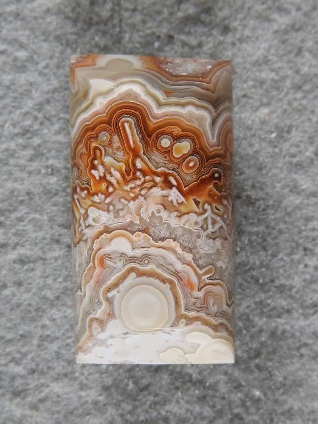 Crazy Lace Agate 692:  I love the Oranges framing the needles in these Crazy Lace stones.  A half barrel cut here with a great pattern.