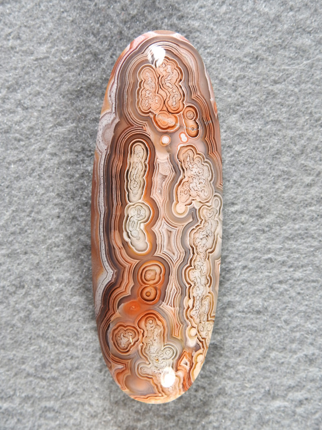 Crazy Lace Agate 695  :  A standard elliptical cut of great patterned Crazy Lace.  This rough was entirely made up of strings of bubbles tied together.  Made for some stunning cabs.