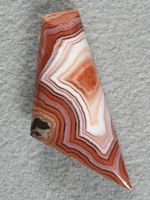 Dryhead Agate 438  :  Fantastic color changes in this one.  Solid crystal center, Pinks Whites, Oranges alternating.  Very striking.