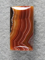 Laguna Agate 1496 : Another of the tight banded Laguna Red to Orange cabs. A high dome bar here.