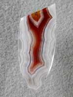 Laguna Agate 68  :  It is hard to capture a shadow effect in a picture.  Shadow is when alternating bands are so close together that when the eye or stone is moved it looks like a hologram as the band shadows move.  This is one of the best.