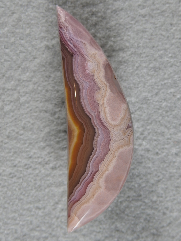 Laguna Agate 1886  :  A slender moon shaped cab with dramatic pastels to solid colors.  A glossy finish tops off this cab.