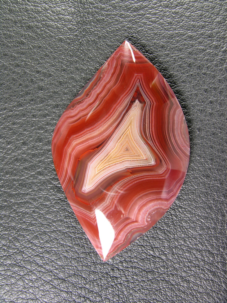 Traded Laguna Agate 106T  :  Another beauty.  Those small curved lines are not fractures.  Because of the great finish on these stone those are reflections of my fingers with the camera.