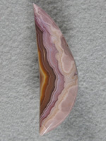 Laguna Agate 1886  :  A slender moon shaped cab with dramatic pastels to solid colors.  A glossy finish tops off this cab.