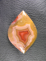 Traded Laguna Agate 108T  :  Another stone that I love.  I wanted to make sure and keep that pink bullseye at the base and with the Yellow and that pretty Red coming up in the center.  This would make an ellegant necklace.