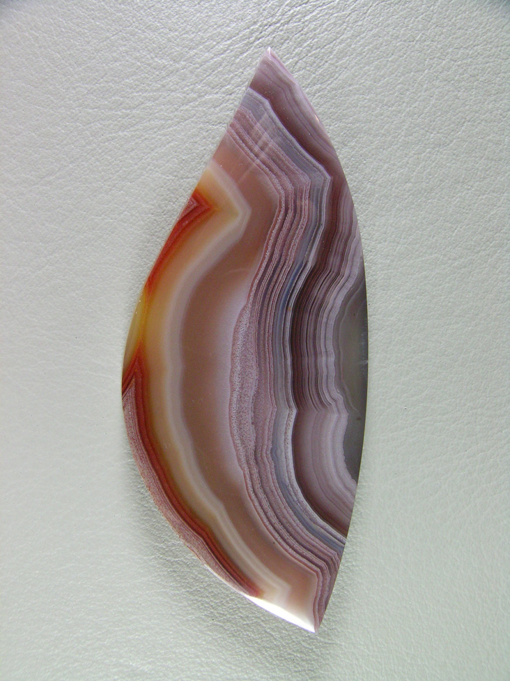 Traded Laguna Agate 122T  :  Another gemmy cab from a classic location.  The tight bands and color and I cut the shape to play on the Red border which worked out perfectly.