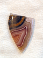 Traded Laguna Agate 139T  :  An Iron spray of Sagenite at the top of the stone adds flavot to this Tan Red combo.