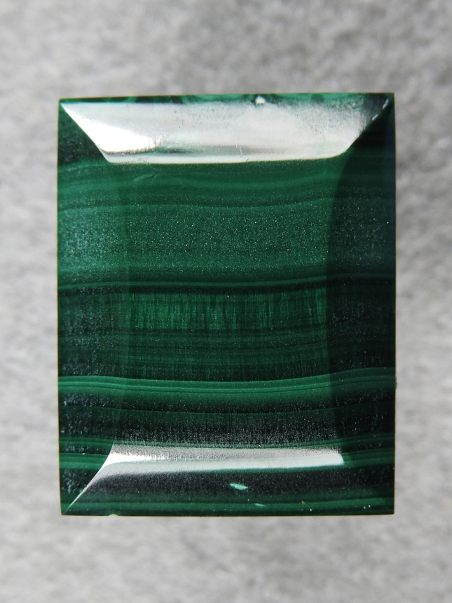 Malachite 459  :  A simple rectangle cut with Beveled sides.  A chatoyant center band.