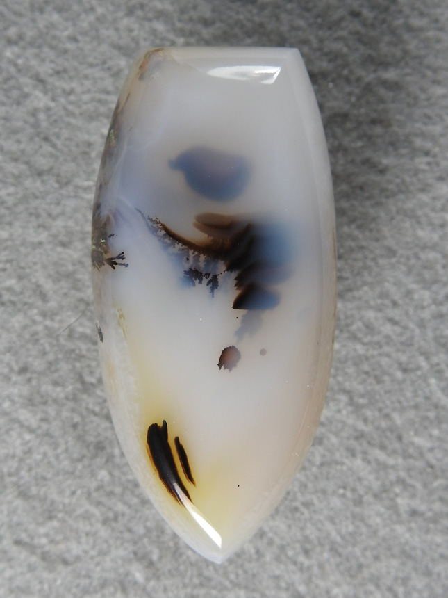 Nipomo Dentritic Agate 803  :  I found this in the creek one day after a heavy rain.  The previous cab came off the same piece.  There is also sagenite coming up the sides of the cab.