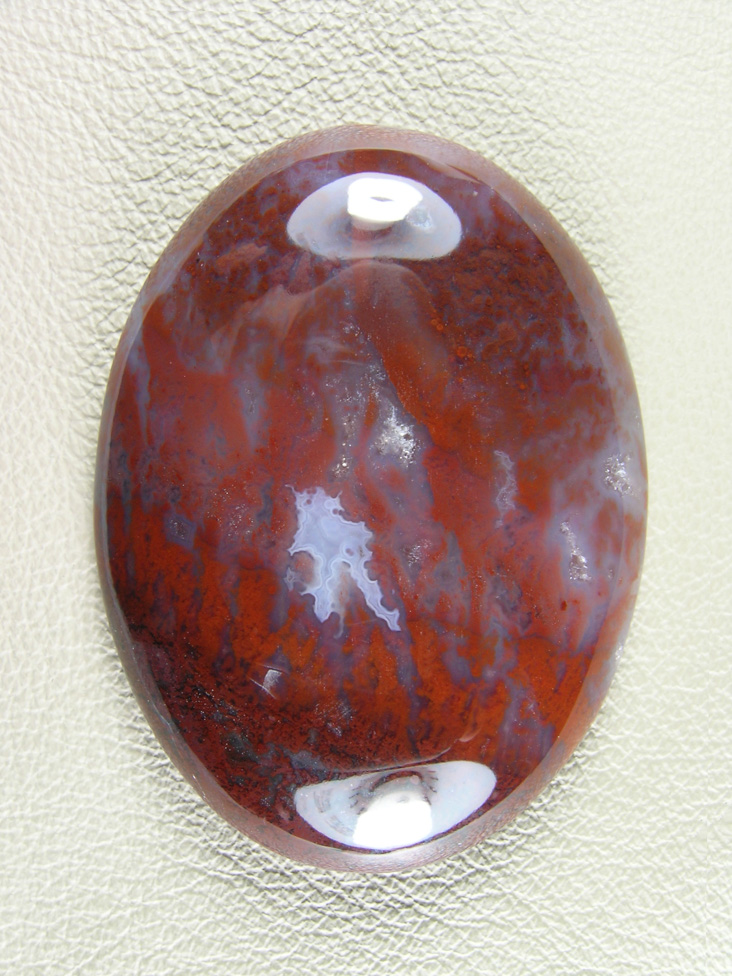 Coronary Plume Agate 655  :  A large traditional cut with well contrasted Plumes running all across the stone over the milky cente.  A pretty Bright White floater sets it off.