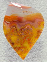 Apache flame agate 317  :  This large cab shows the classic water clear and Yellow/Orange swirls but also has Plumes running all thru the Yellow area at the base