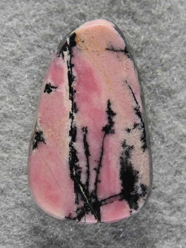 Rhodochrosite 1543 : A very nice freeform of Rhodonite. I love the contrast of the pink and Black in this material.