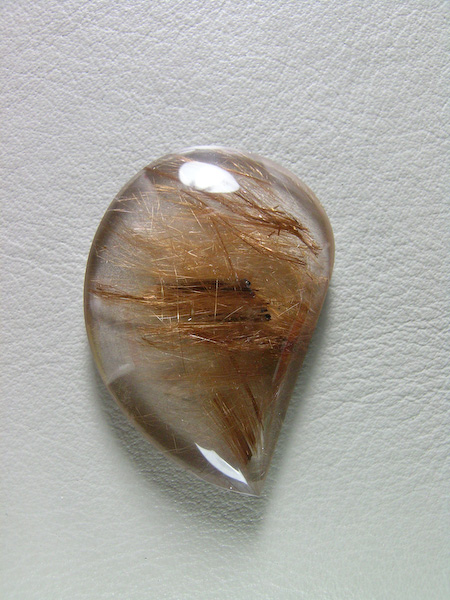 Traded Rutilated Quartz 1066T  :  A very optical Quartz with Brassy Golden needles.  From Brazil this material is elegant and a pleasure to cut.